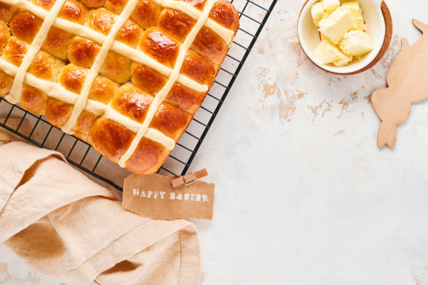istock Easter Hot Cross Buns. Traditional breakfast and Easter baking holiday decorations rabbiton white wooden background. Bright colors, view from above on wooden table. 1307040216