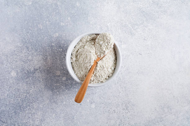 istock Closed collagen in a ceramic bowl on an old gray concrete background. Flat lay with copy space 1307040347