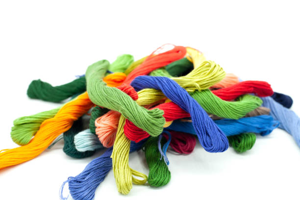 New multicolored embroidery threads are in a straw basket for needlework. Materials for creativity in vintage style.