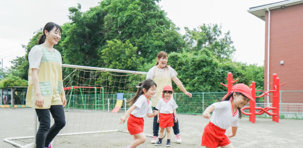istock Children play outside at nursery school 1307042918