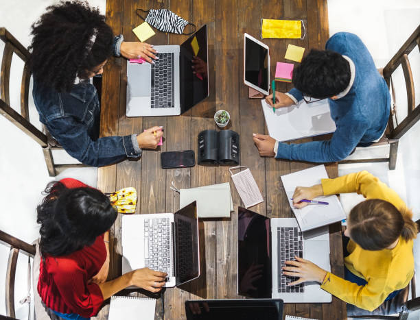 istock Multiracial group studying toghether in library coffe shop 1307043368