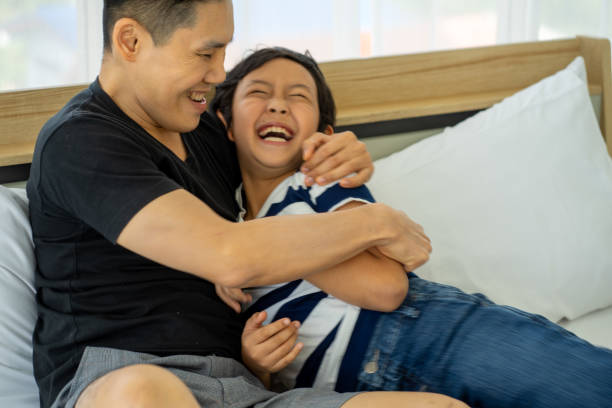 istock Asian father business man work from home playing with son boy on ned 1307045597