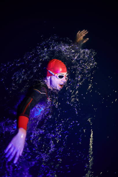 istock real triathlon athlete swimming in dark night 1307045947