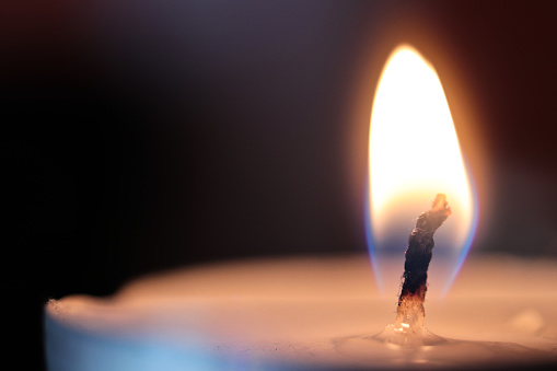 Close up macro photo of a burning candle wick