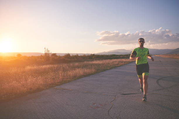 istock triathlon athlete running on morning trainig 1307048153