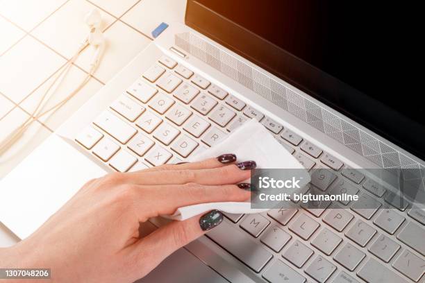 Woman Cleaning Computer Keyboard Female Hands Disinfecting Laptop Keyboard With Antivirus Wet Wipes Cleaning And Disinfecting Laptop Computer With Wet Wipes Stock Photo - Download Image Now