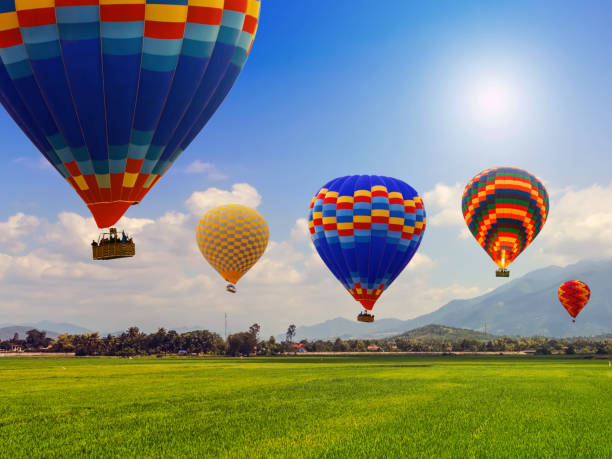 istock Hot air balloon team flying blue Sky landscape meadow 1307049336