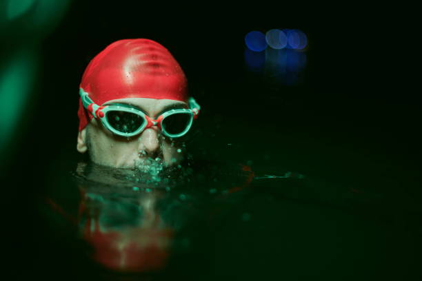 istock authentic triathlete swimmer having a break during hard training on night neon gel light 1307049733