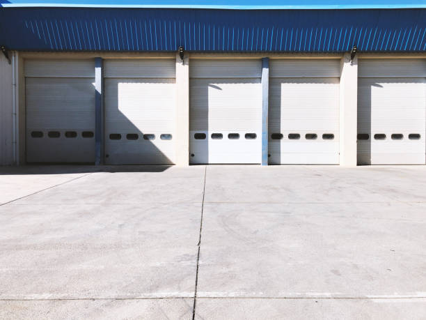 istock Hangar gates with blue roof and concrete floor. 1307049864