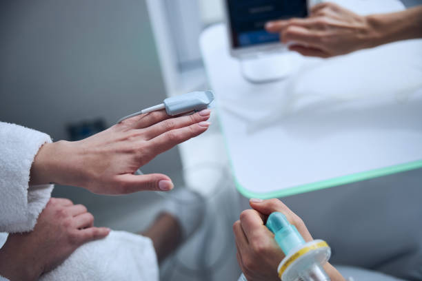 istock Patient having her oxygen saturation level measured by a pulmonologist 1307050532