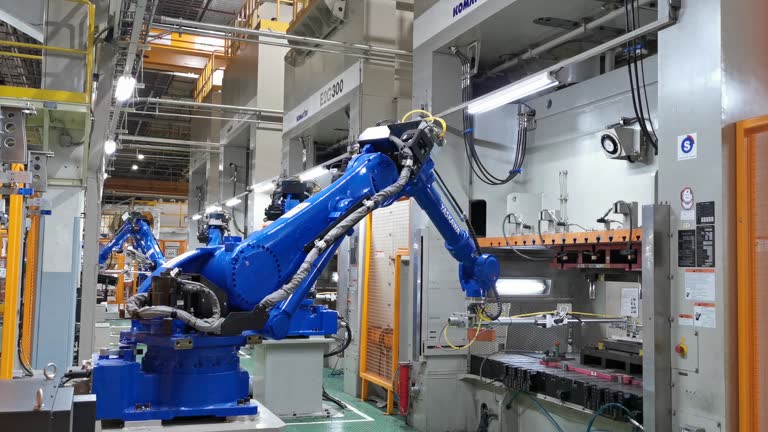 Robot arm with Iron press machine working in factories, 4k resolution.