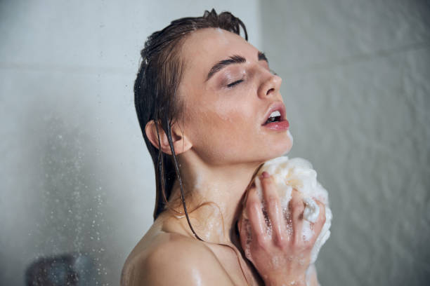 istock Relaxed young female washing herself in the bathroom 1307050871
