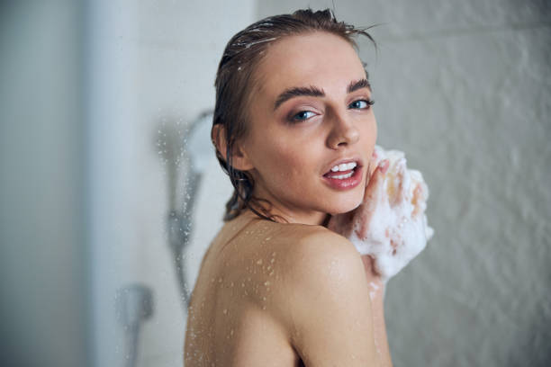 istock Tranquil lady washing herself in the bathroom 1307050907