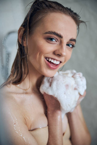 istock Merry cute lady enjoying her water procedure 1307050911