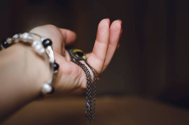 Orthodox cross in the hands of woman mother during baptism, concept hope, close-up