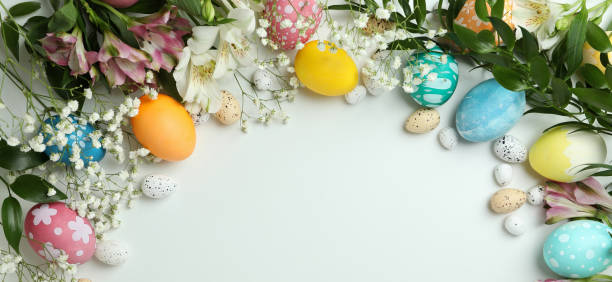 istock Easter eggs and beautiful flowers on white background, space for text 1307052003
