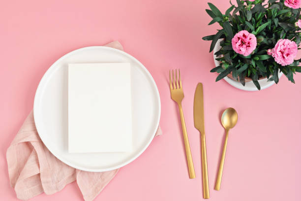 istock Flat lay with mockup menu and easter decoration. White plate over pink background 1307052104