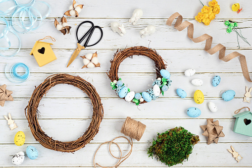Handmade diy home interior decoration wreath with easter eggs and natural elements. Flat lay, top view creativity craft concept