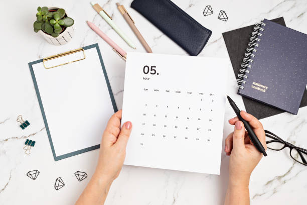 istock Desktop with calendar for may and office supplies 1307052314