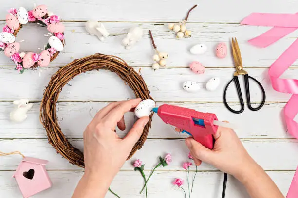 Photo of Handmade diy home interior decoration wreath with easter eggs in pink color