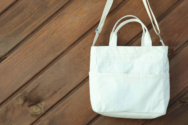 istock Stylish blank eco bag on wooden background 1307052332