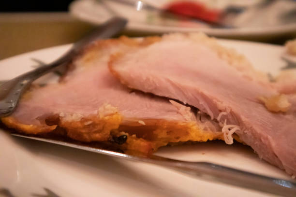 istock Carving glazed ham on the plate 1307052480