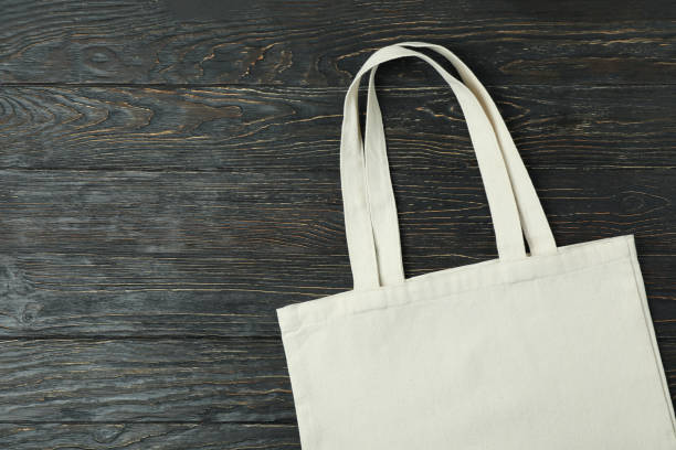 istock Eco bag on wooden background, space for text 1307052844