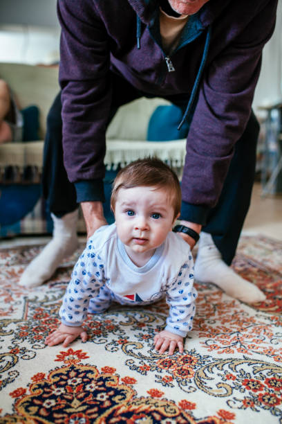 istock Grandfarher helping to learn  walking his grandson 1307053912