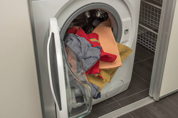 istock Close up view of washed laundry in a laundry  machine. Home routine concept. Sweden. 1307054950