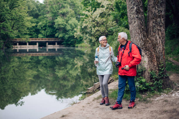 istock Happy seniors enjoying together exploring the riverside 1307057902