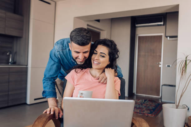 istock Happy couple using a laptop and enjoying together 1307058106