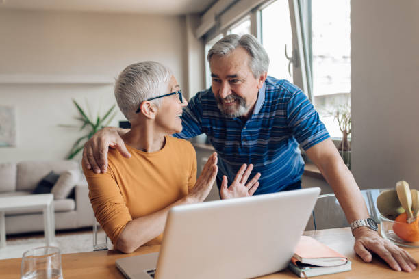 istock Senior man helping his wife to work online 1307058220