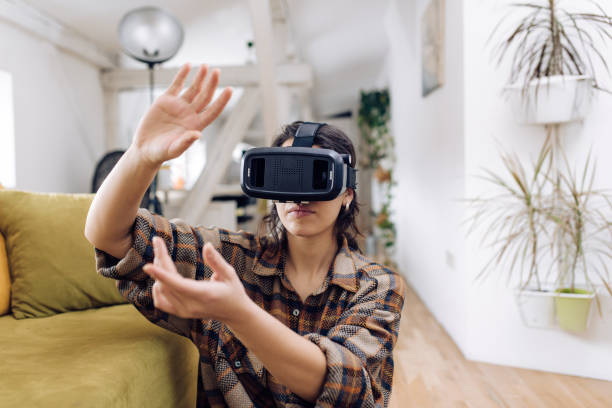 istock Young woman wearing virtual reality headset and having fun 1307058350