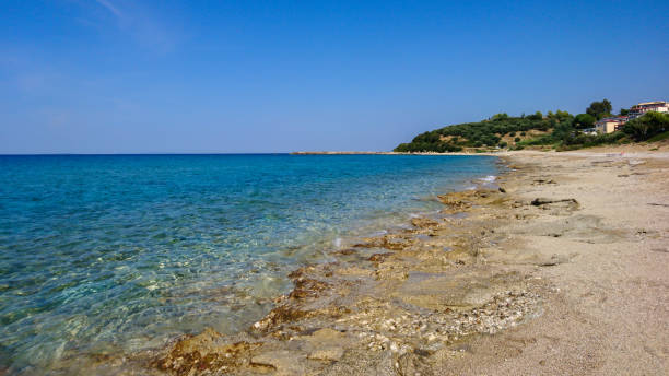 istock Sunny clear calm blue sea shore beach, Greece 1307059281