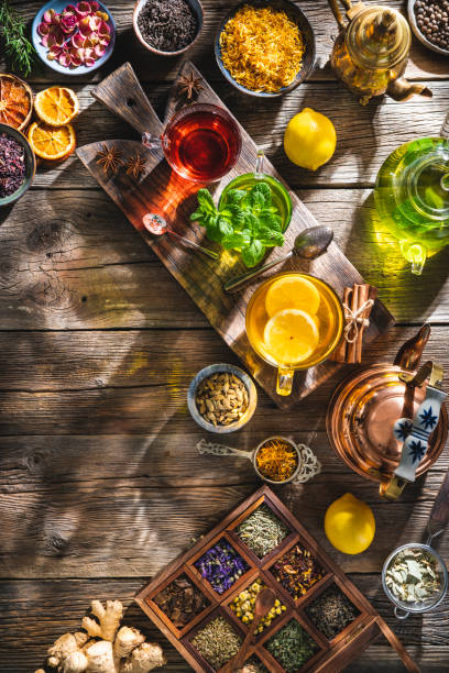 Tea and herbal infusion with dried herbs on wooden rustic table board