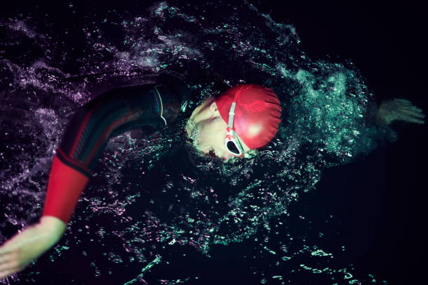 istock real triathlon athlete swimming in dark night 1307061842