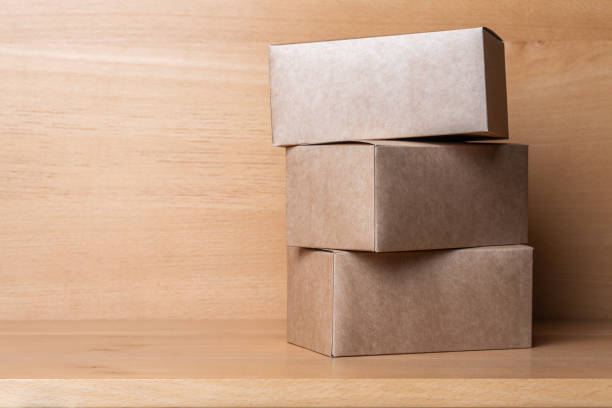 istock Packaging boxes for cakes, gifts or parcels on a wooden table. 1307061931