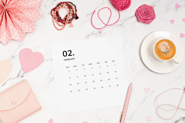 istock Desktop with calendar for february and pink accessories 1307063219