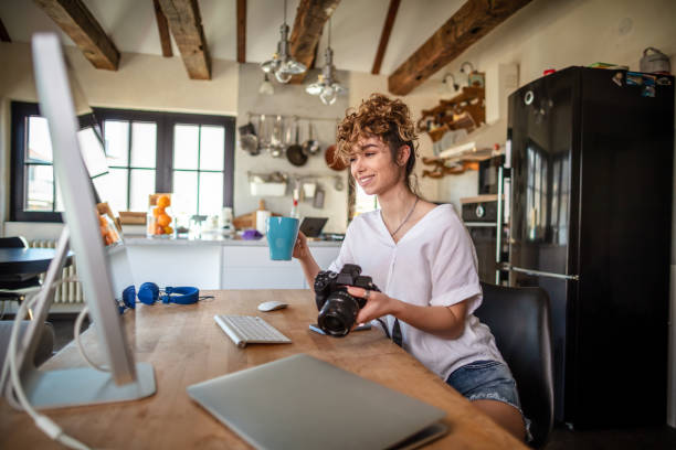 istock Young photographer working in her home office 1307065694