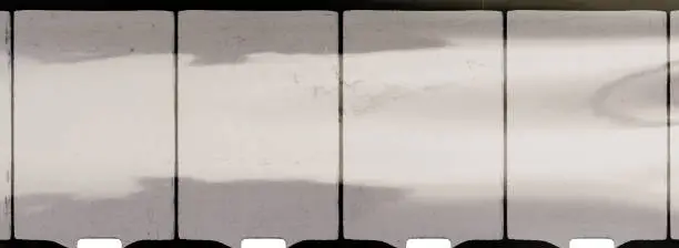 Photo of empty or blank 8mm film frame with black border and dust.