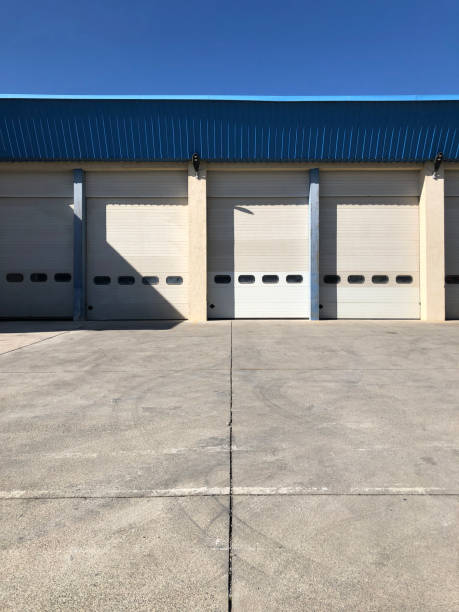 istock Hangar gates with blue roof and concrete floor. 1307068841