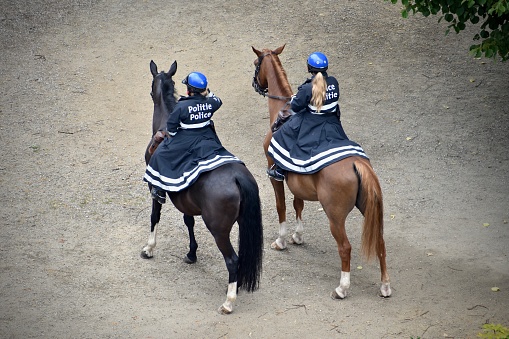 Brussels / Belgium - July 2020 : Two mounted police officers waiting at street as back up force