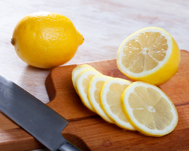 istock Sliced lemon on wooden table 1307072498