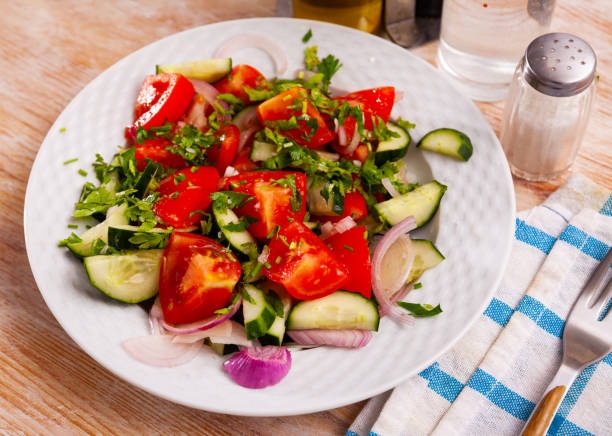 istock Vegetarian salad  with  fresh cucumbers, tomatoes, onion 1307072502