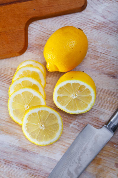 istock Lemon slices on wooden background 1307072507
