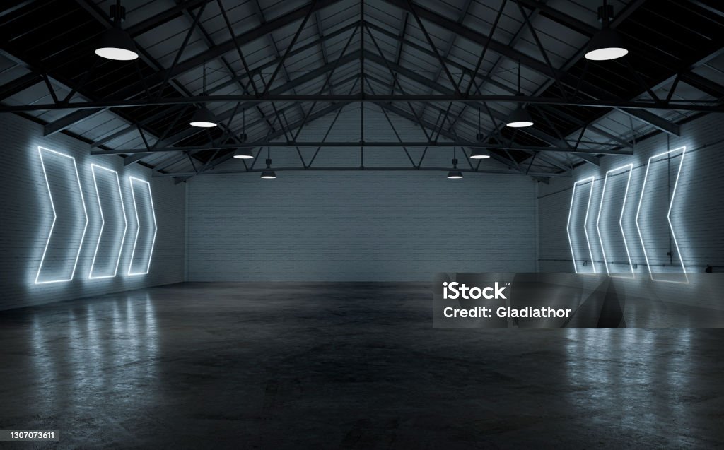 Empty warehouse interior illuminated by white neon lights Empty large warehouse interior with cement floor, illuminated by white arrow shaped neon lights from side brick walls. A large blank brick wall background with copy space in the center. 3D rendered image. Studio - Workplace Stock Photo