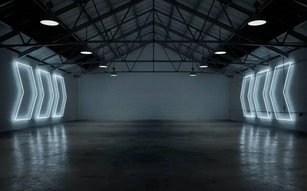 Photo of Empty warehouse interior illuminated by white neon lights