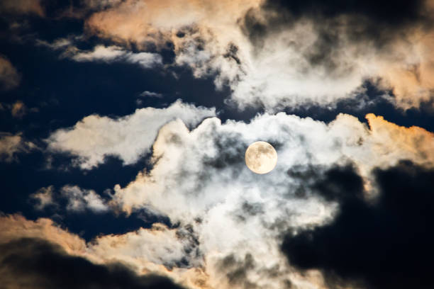 istock Full moon shining through the sky at night 1307074907