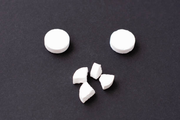 istock Pills. Medical pills and capsules. Isolated on a black background. A fast-dissolving, effervescent tablet, allergy pill, antibiotics. Virus and flu Diseases in Winter. 1307075911
