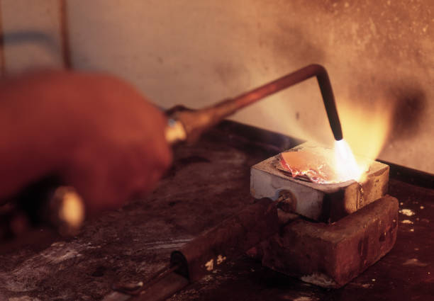 istock Jeweler melting silver with blowtorch 1307075992